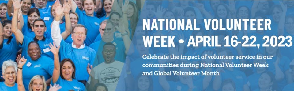 Group of people with blue t-shirts waving and smiling toward the camera, national volunteer week April 16-22, 2023